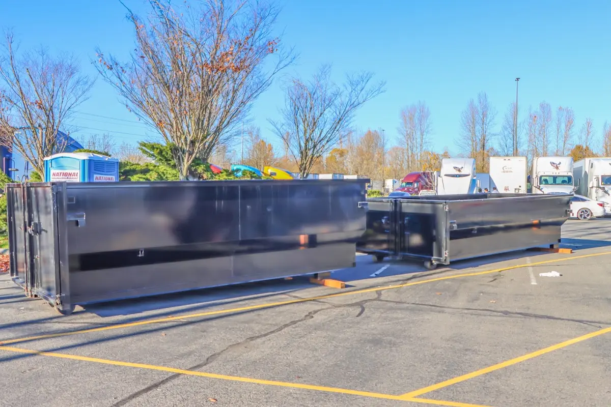 Professional dumpster rental service with roll-off container on residential driveway in North Laurel